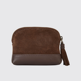 Brown leather coin purse with a tassel on a light grey background