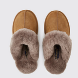 Pair of brown slippers with fluffy fur on a white background