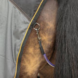 Close-up of a horse's tail with a clip and fillet string