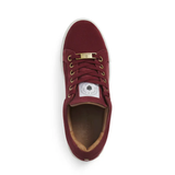 Maroon trainer with gold laces on a white background