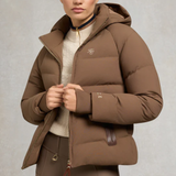 Brown puffer jacket with a brand logo worn by a person on a neutral background