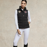 Woman styles the Holland Cooper Team HC Gilet in Black with white breeches and long sleeve t-shirt