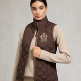 Woman wearing a brown quilted gilet with a logo on a light grey background