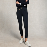 Person wearing black riding tights with gold buttons on a neutral background