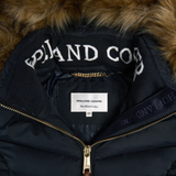 Navy jacket with fur hood and visible Holland Cooper branding