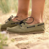 Person stands on the sand wearing the Le Chameau Ladies Galion Femme Shoe in Vert Vierzon