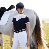 Woman stands by horse wearing the LeMieux Emily Short Sleeve Show Shirt in Navy