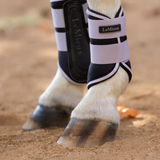 Horse leg with protective boot and LeMieux branding on a sandy background