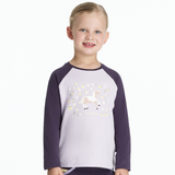 Child wearing a purple and white shirt with a unicorn design on a white background