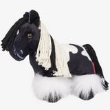 Black and white plush horse toy on a white background