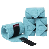 Set of light blue horse leg wraps with black straps on a white background