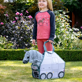 Child holding a toy horse in a carrying case outdoors