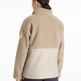 Beige fleece jacket worn by a person on a white background