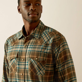 Man wearing a plaid shirt with a neutral background