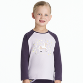 Child wearing a purple and white shirt with a unicorn design on a white background