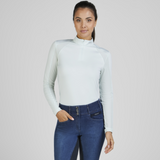 Rider wears the Pikeur Sports Mesh Long Sleeve Baselayer in Ice Blue with jeggings