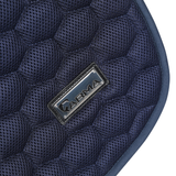 Close-up of a navy blue quilted saddle pad with a brand logo on a white background