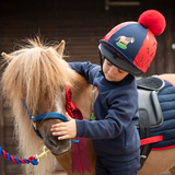 Child pets pony wearing the Shires Winnie & Me Hat Silk