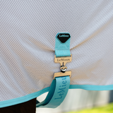 Close-up of a turquoise horse rug strap with 'LeMieux' branding on a white mesh background.