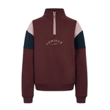 LeMieux AW26 Young Rider Viola Quarter Zip Sweat Variant Colour Bramble.
A quarter-zip sweatshirt by Lemieux in bramble, featuring light pink color-blocked shoulder panels and part navy sleeve panels, with a pink zipper and white embroidered logo on the chest. On white background.