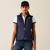 Person wearing a navy gilet and cap with visible Ariat brand logo on a beige background