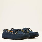 Pair of navy blue loafers on a light beige background