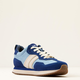 Blue and light blue trainers with white laces on a beige background