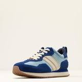 Blue and light blue trainers with white laces on a beige background