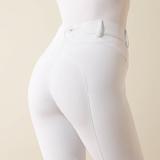 Close up of white riding breeches on a beige background