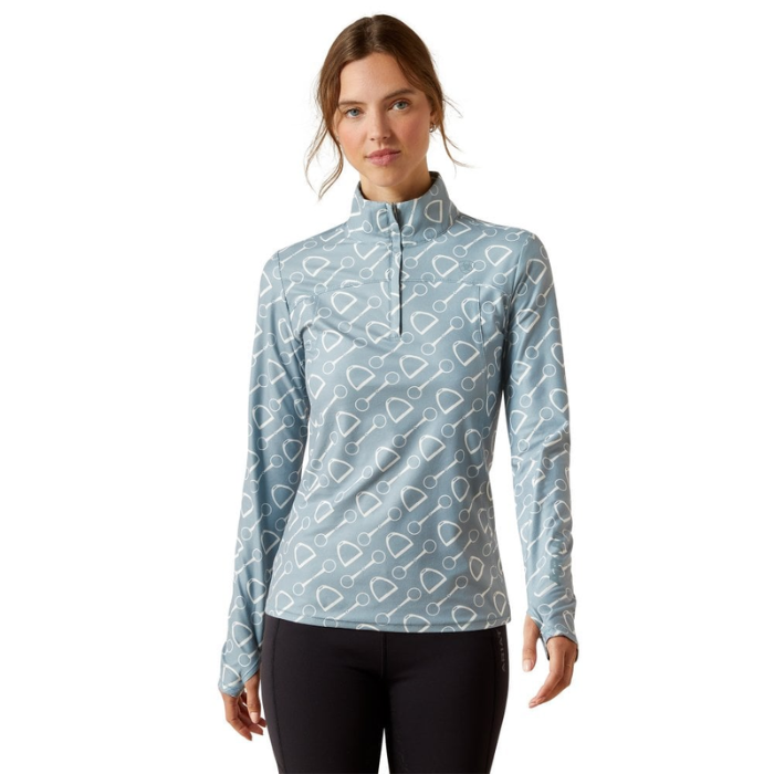 Woman wearing a light blue patterned long-sleeve shirt on a white background