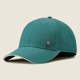 Green baseball cap with brand logo on a beige background