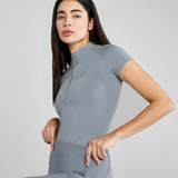 Woman wearing a blue athletic outfit on a light grey background