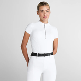 Woman wears a white short sleeve base layer and white breeches on a light grey background