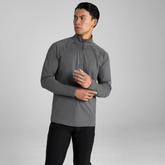 Man wearing a grey long-sleeve athletic shirt against a grey background