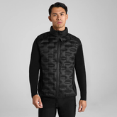 Man wearing a black long sleeve top and gilet with black breeches on a grey background