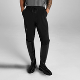 Male figure wearing black training pants with riding boots