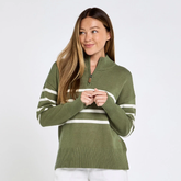 Woman wearing a green sweater with white stripes on a plain background