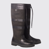 Pair of black riding boots with straps on a light grey background