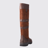 Brown leather boot with a strap on a light grey background