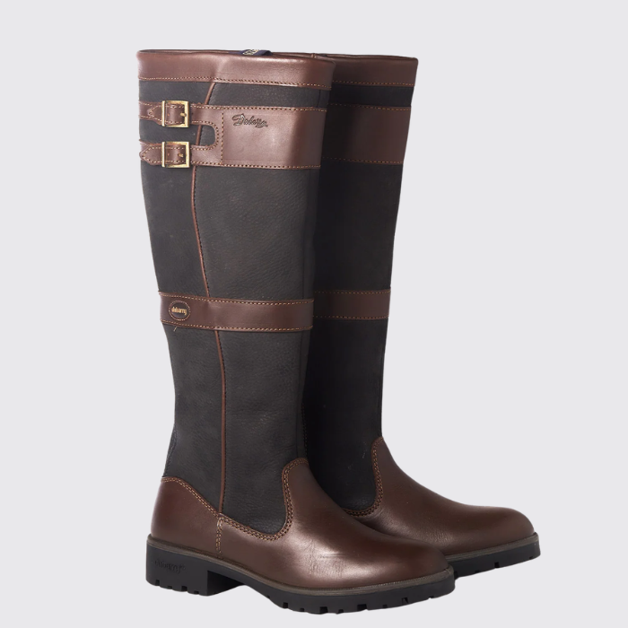 Pair of dark brown country boots with straps on a light grey background