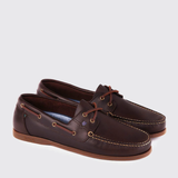Pair of brown deck shoes on a light grey background