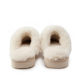 Pair of white fluffy slippers on a white background