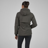 Person wearing a khaki green jacket on a grey background