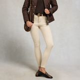 Person wearing a brown quilted jacket, beige jeans, and dark brown shoes on a plain background