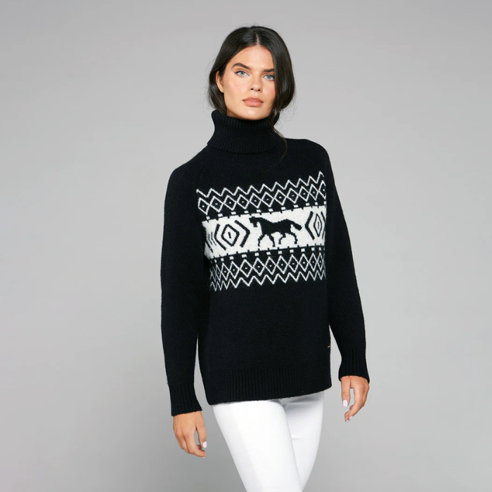 Woman wearing a black sweater with a white pattern on a grey background