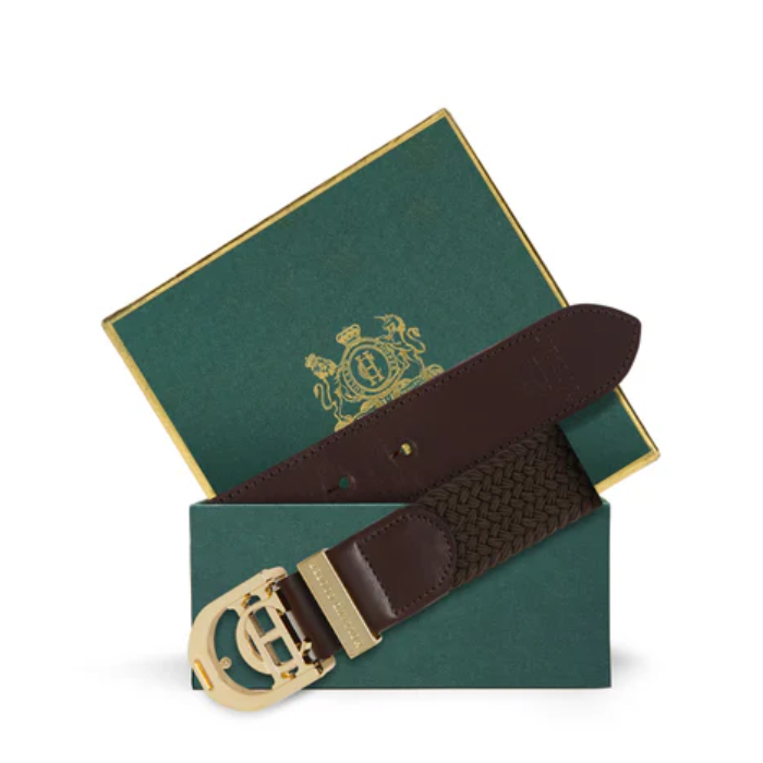 Brown belt with gold buckle on a green box with a logo