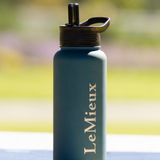 Teal water bottle with 'LeMieux' branding on a blurred natural background