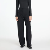 Black waterproof trousers worn against a white background