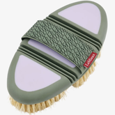 Lilac horse grooming brush with green strap on a white background