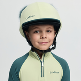 Child wearing a green and yellow LeMieux helmet and outfit on a white background